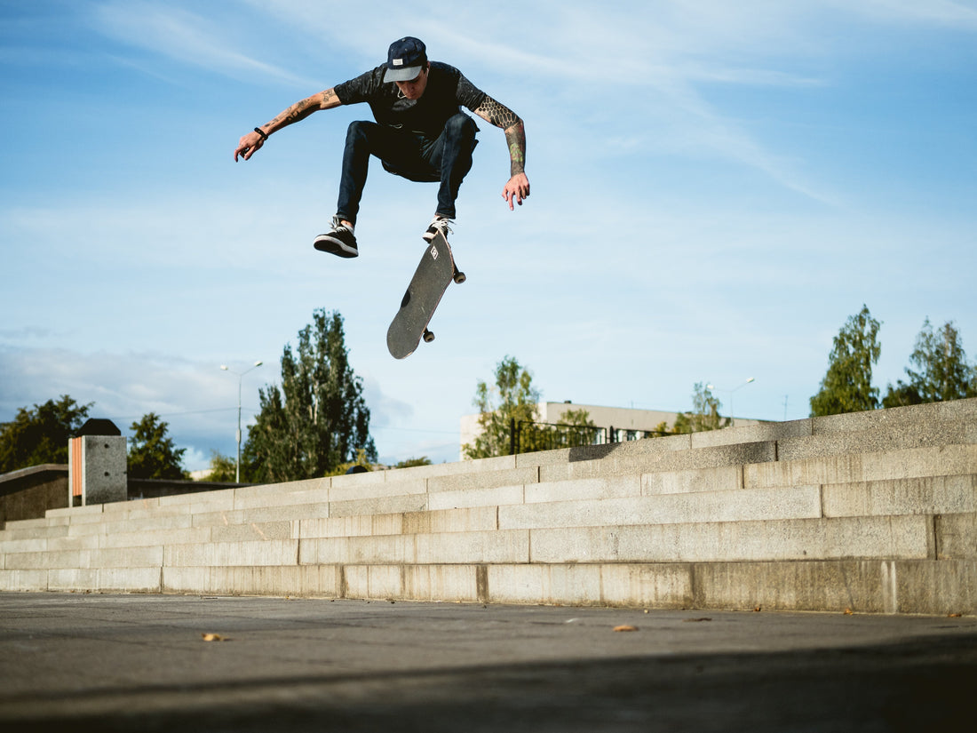 A person mid-air while doing a skateboard trick.