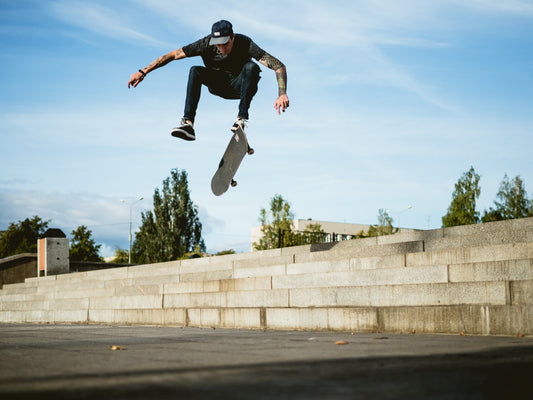 A person mid-air while doing a skateboard trick.